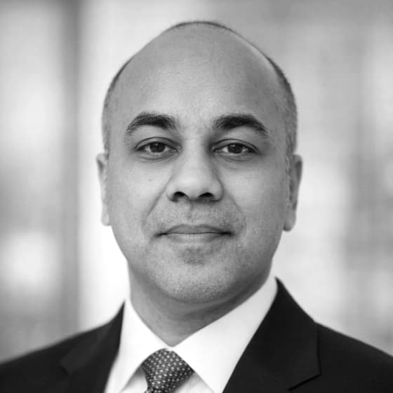 Portrait of Mayur Patil in a dark suit and blue tie